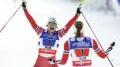 Norway's Maiken Caspersen Falla and  Ingvild Flugstad Oestberg celebrate after crossing the finish line during the Women's Cross